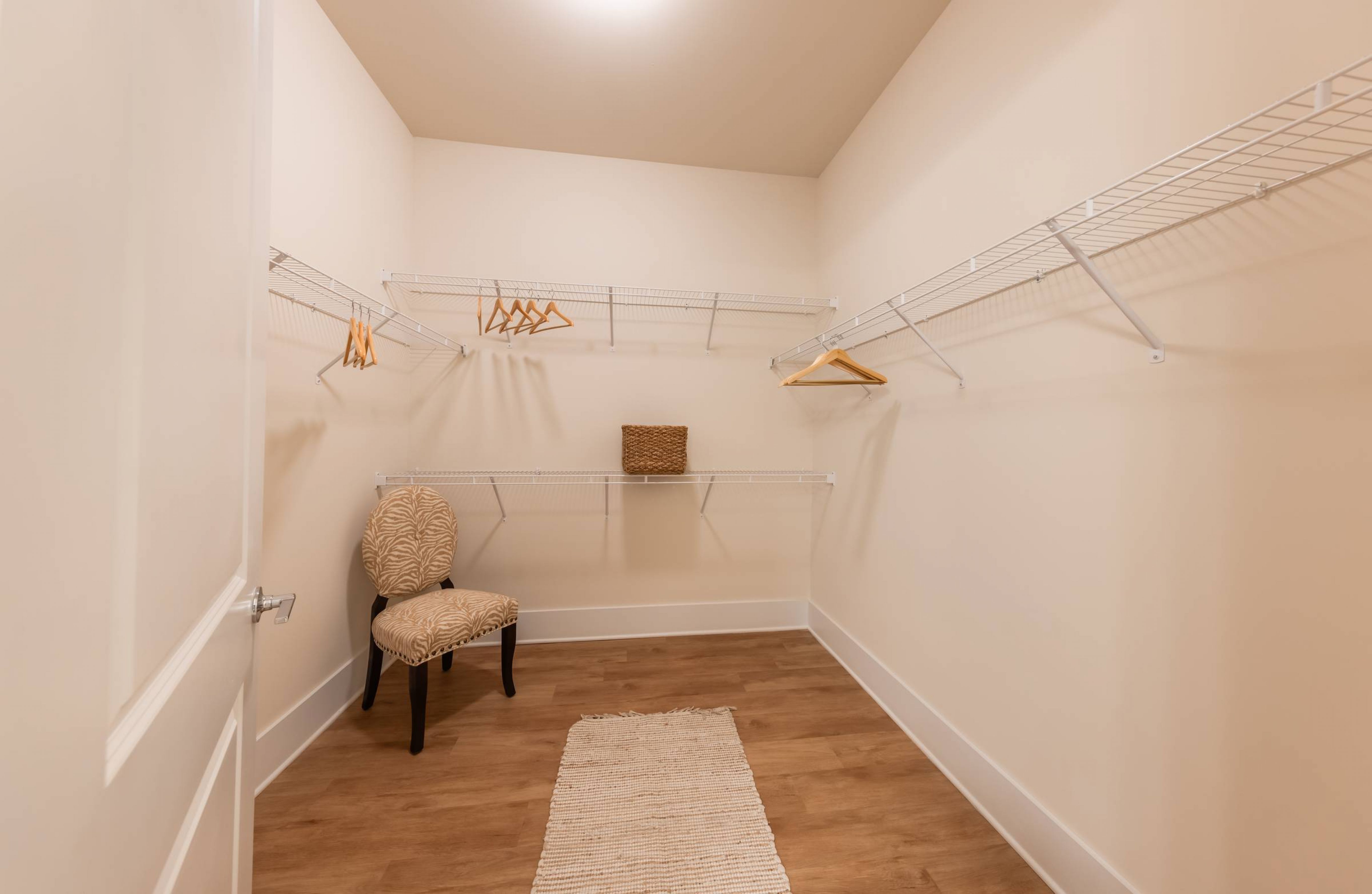 Apartments at holly crest walk in closet with hardwood flooring