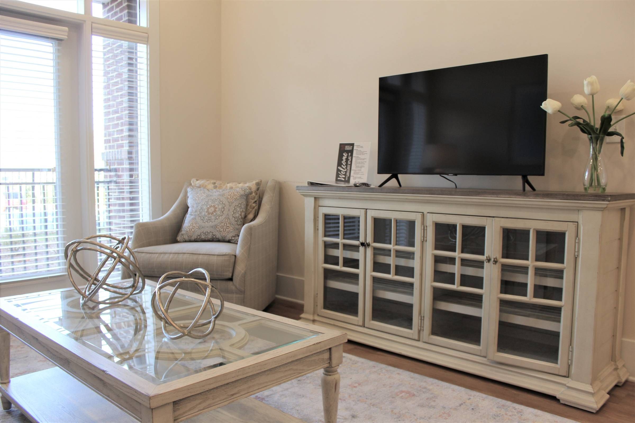 Apartments at holly crest guest suite living room with tv and modern coffee table