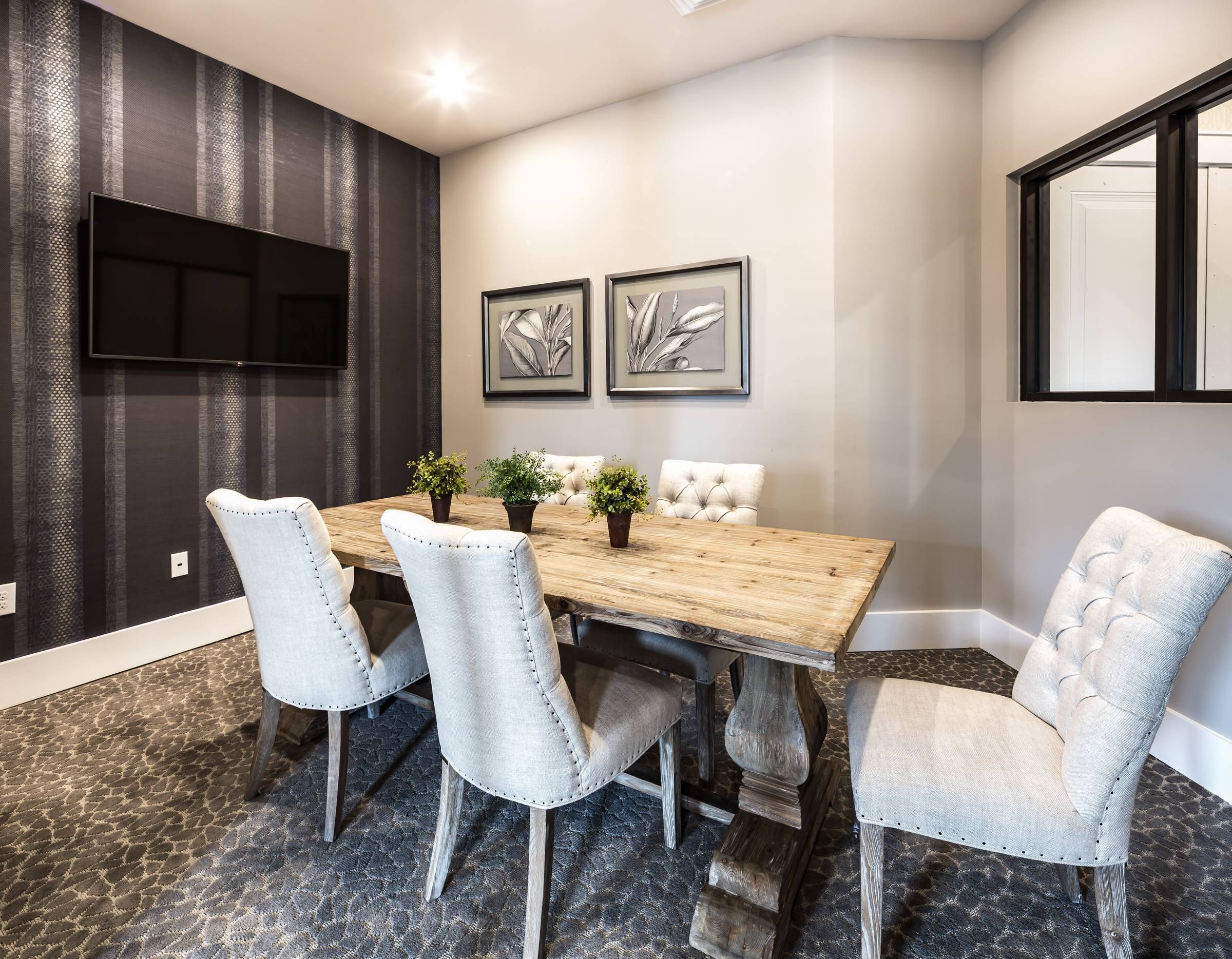 Apartments at Holly Crest conference room with tables and chairs