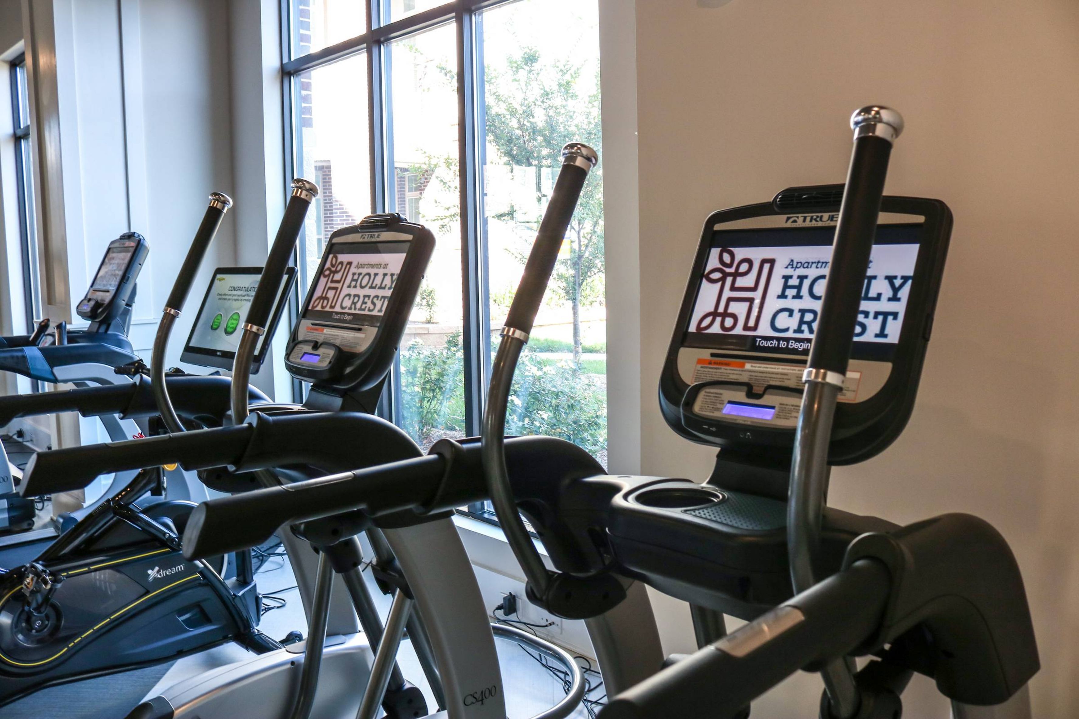 Apartments at holly crest fitness center amenity with cardio equipment